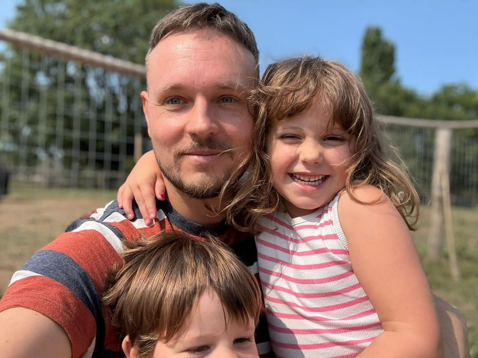Pete with his two children outdoors
